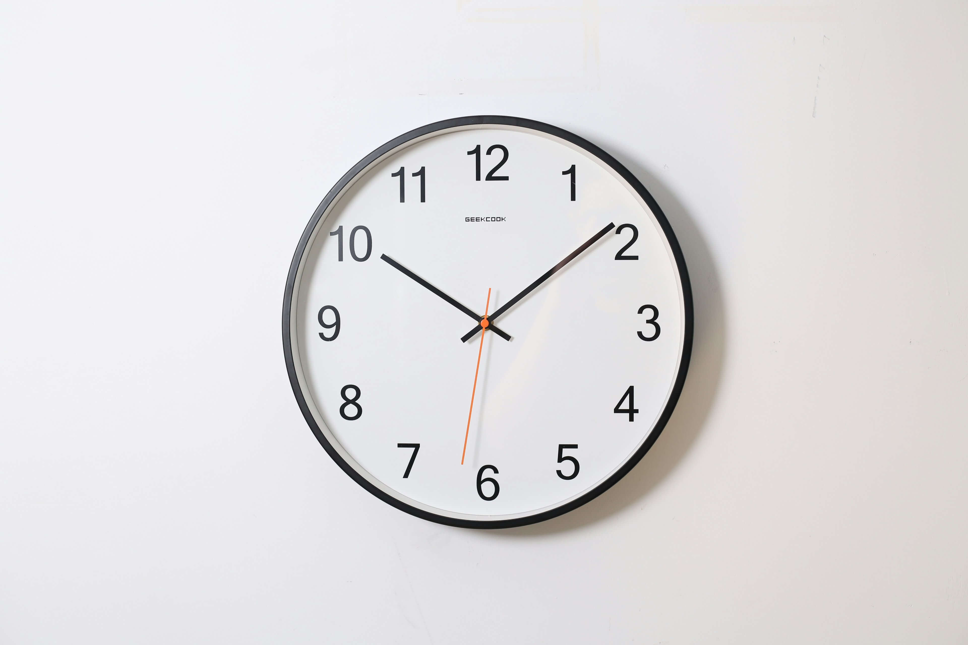 Round wall clock illustrating time and sequence