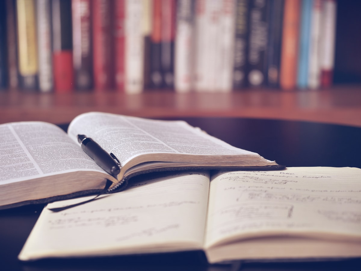A person studying Greek with notebooks and flashcards
