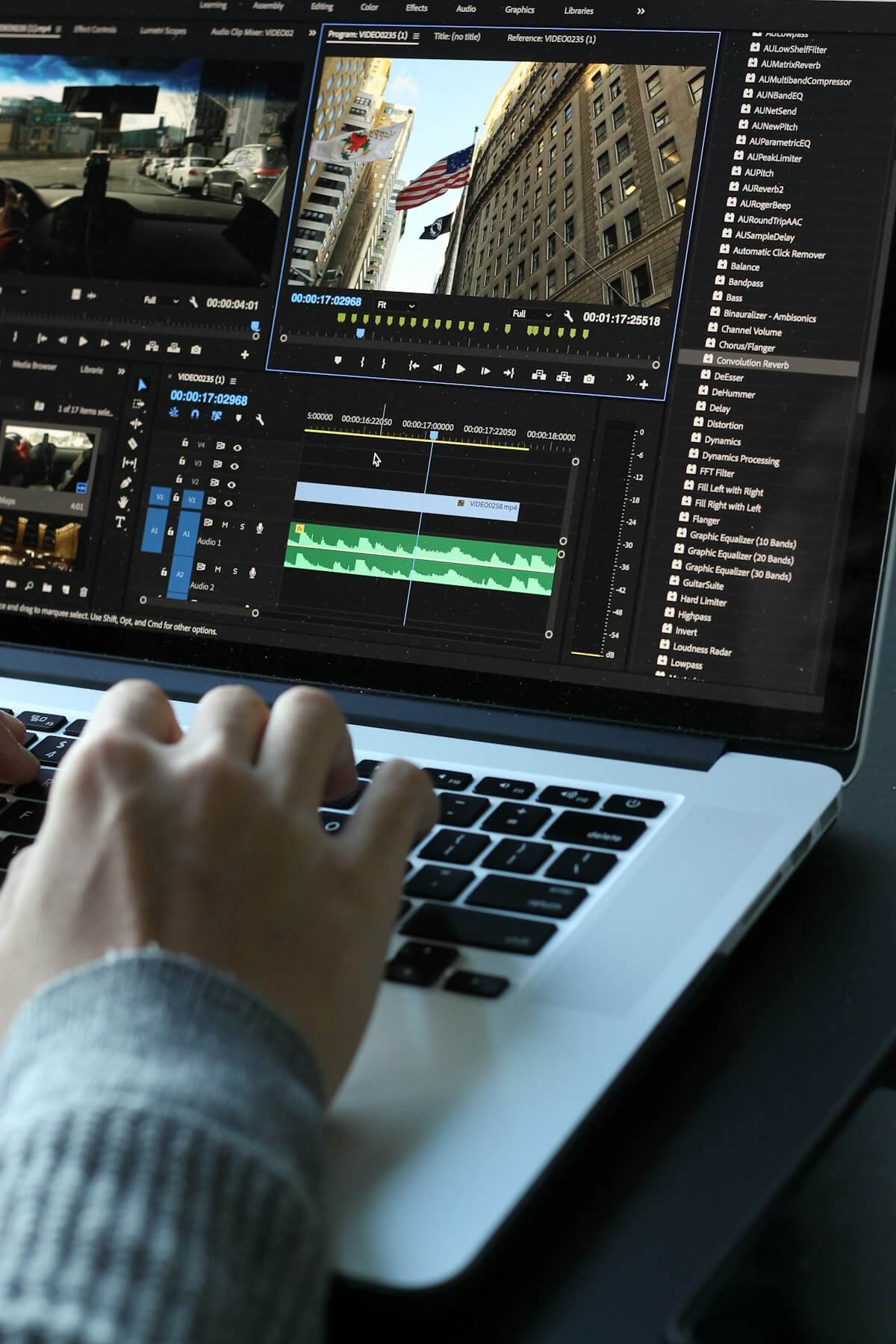 A content creator editing video captions on a laptop