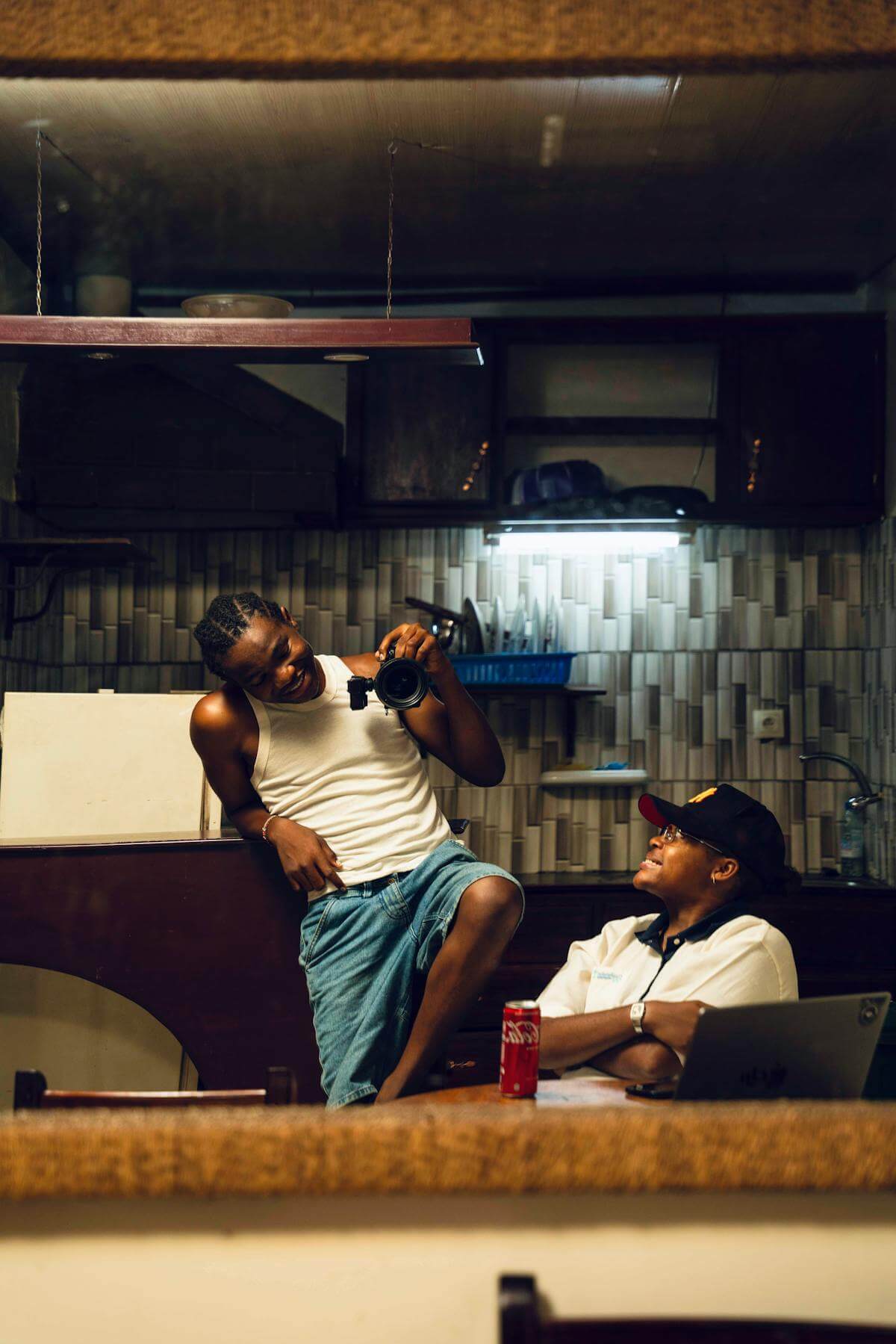Friends gathered in a warm kitchen, laughing and enjoying each other's company